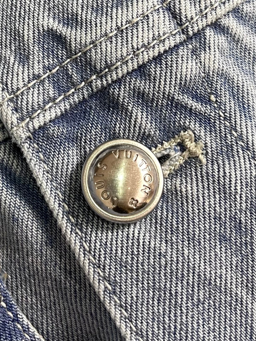 DISTRESSED DENIM TRUCKER JACKET WITH EMBROIDERED DETAILS