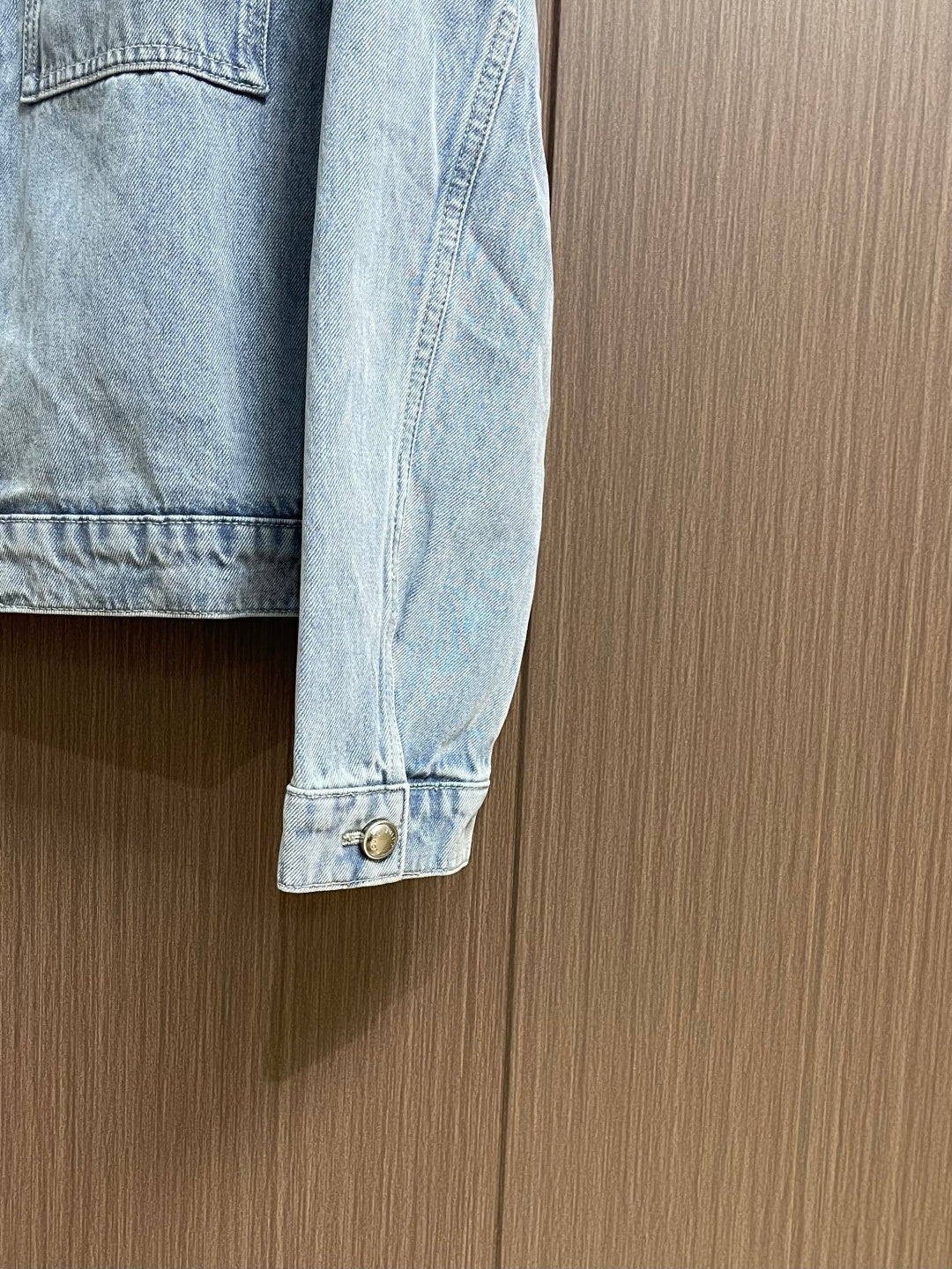 DISTRESSED DENIM TRUCKER JACKET WITH EMBROIDERED DETAILS