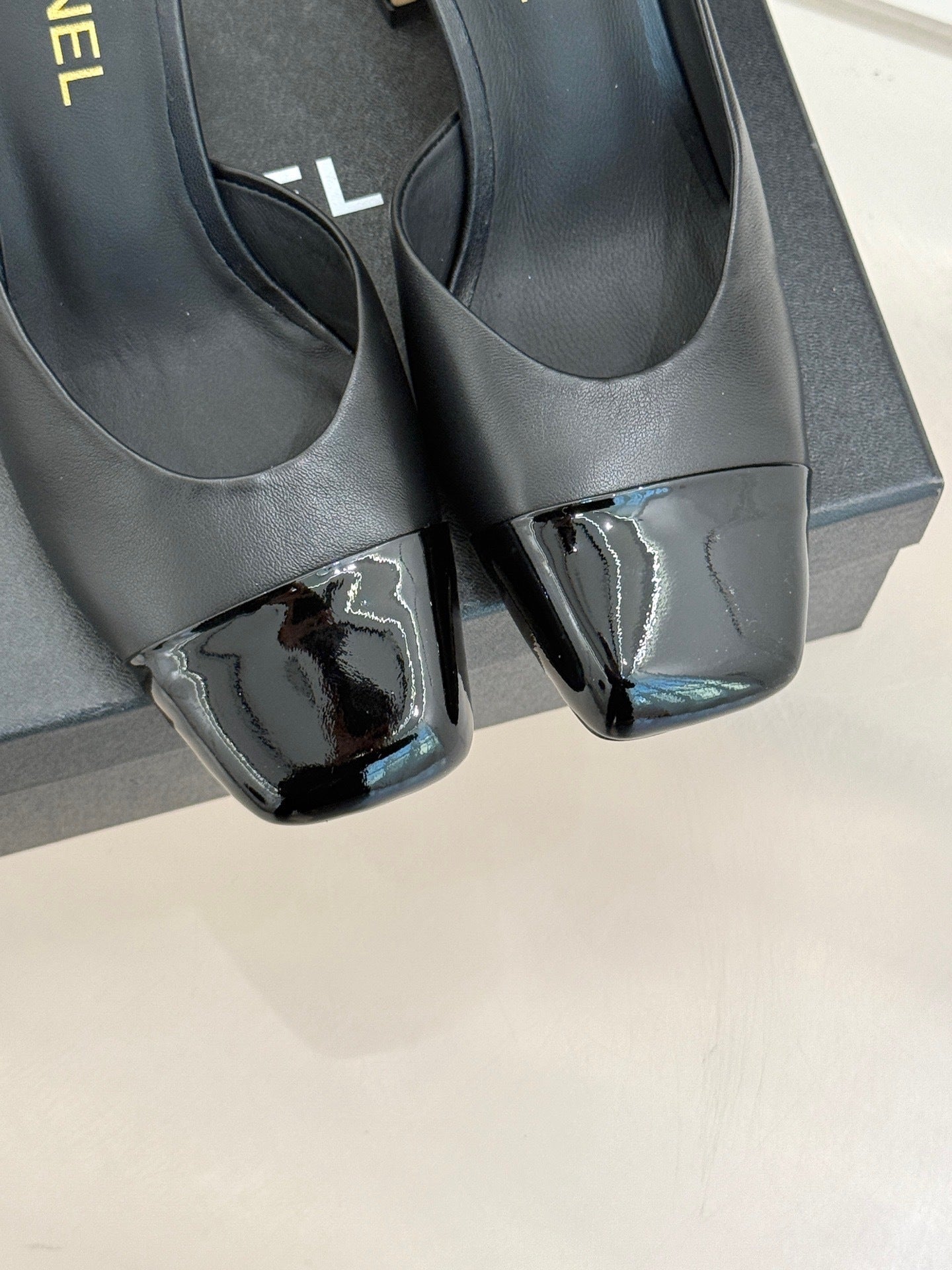 BLACK LEATHER CAP-TOE MULE HEELS WITH GOLD DETAIL