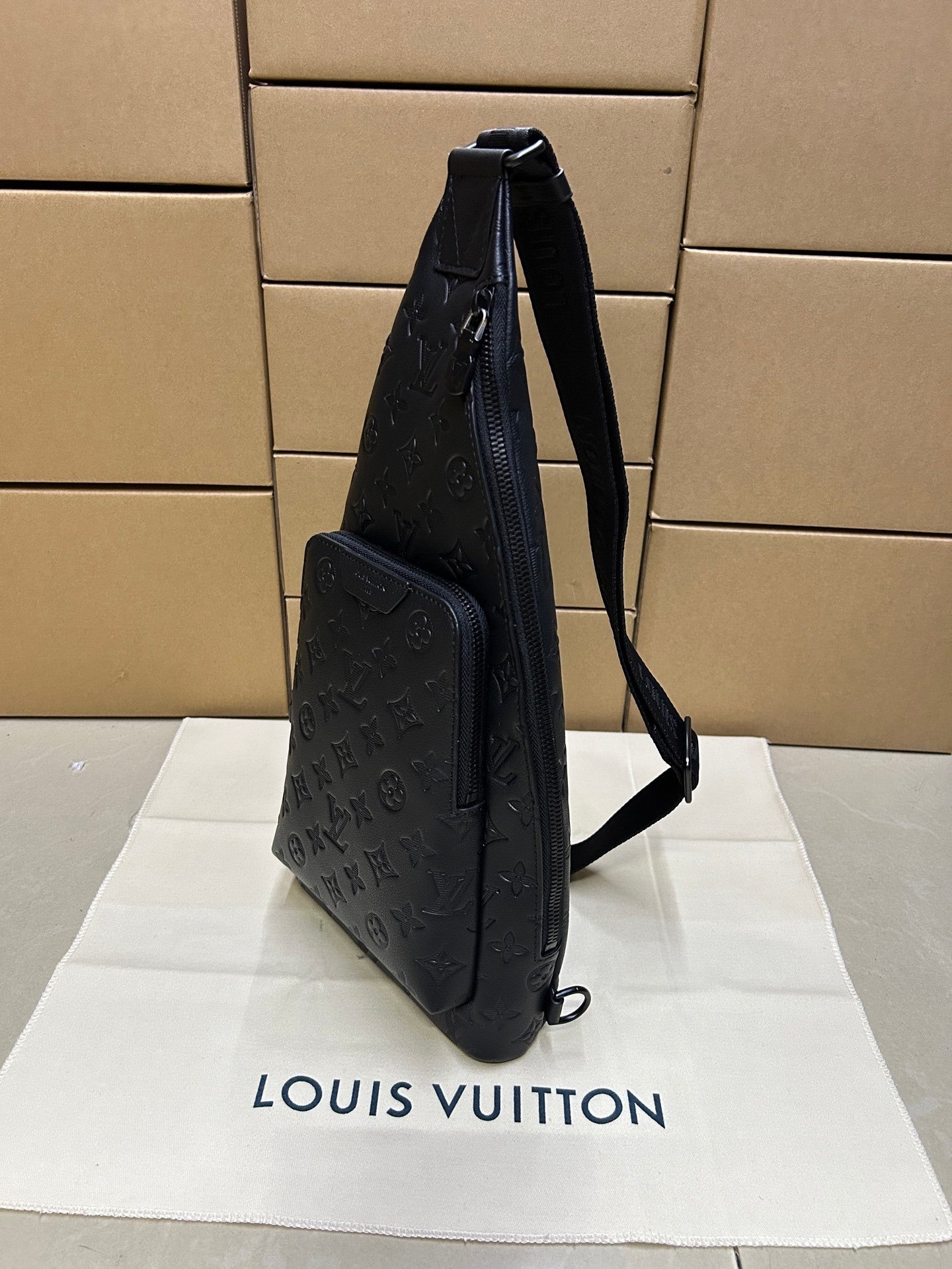 EMBOSSED LEATHER SLING BACKPACK
