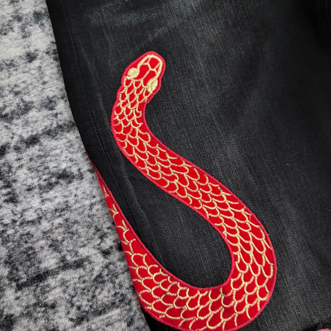 SNAKE GRAPHIC DISTRESSED SKINNY JEANS