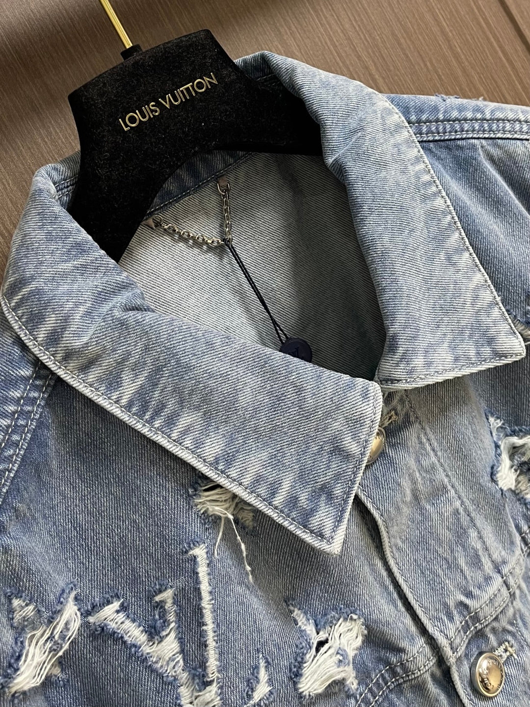 DISTRESSED DENIM TRUCKER JACKET WITH EMBROIDERED DETAILS