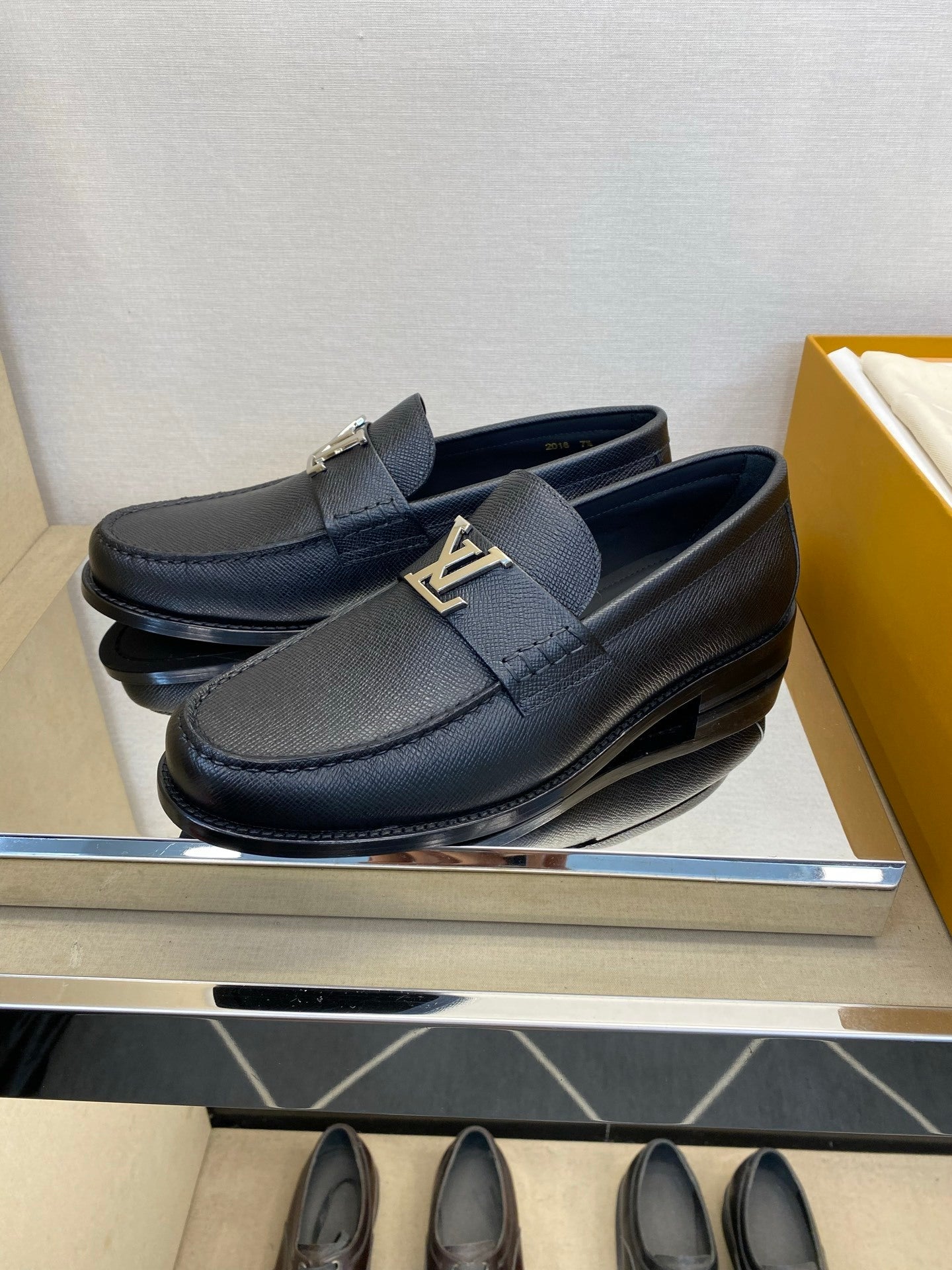 BLACK LEATHER SLIP-ON LOAFERS WITH METAL DETAIL