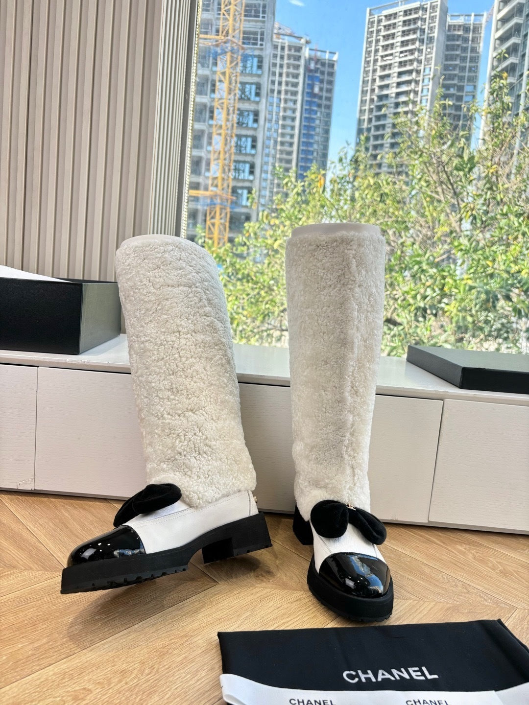 KNEE-HIGH SHEARLING BOOTS WITH PATENT CAP TOE AND BOW DETAIL