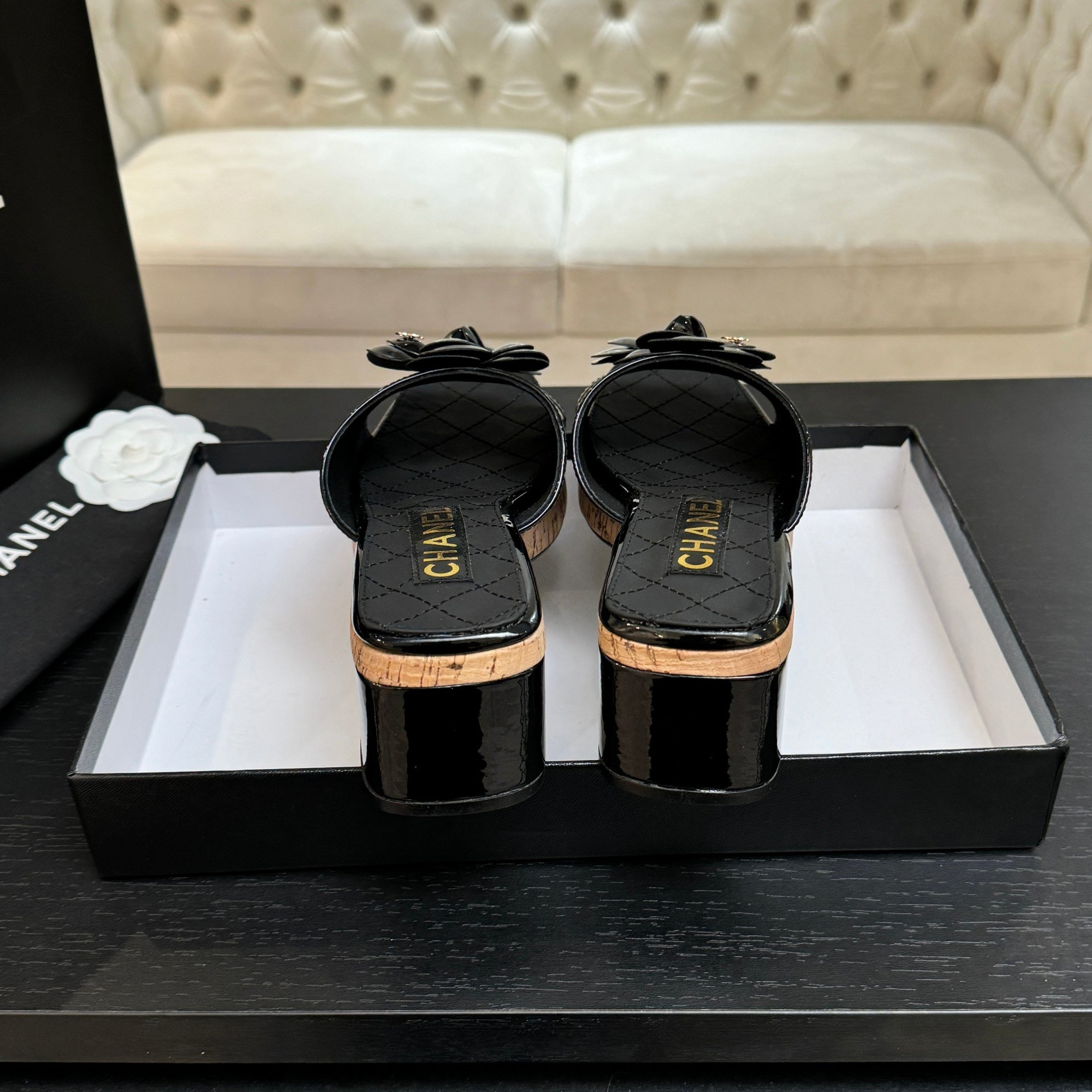 BLACK QUILTED PLATFORM SLIDE SANDALS WITH FLORAL DETAIL