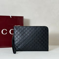 EMBOSSED LEATHER WRISTLET CLUTCH