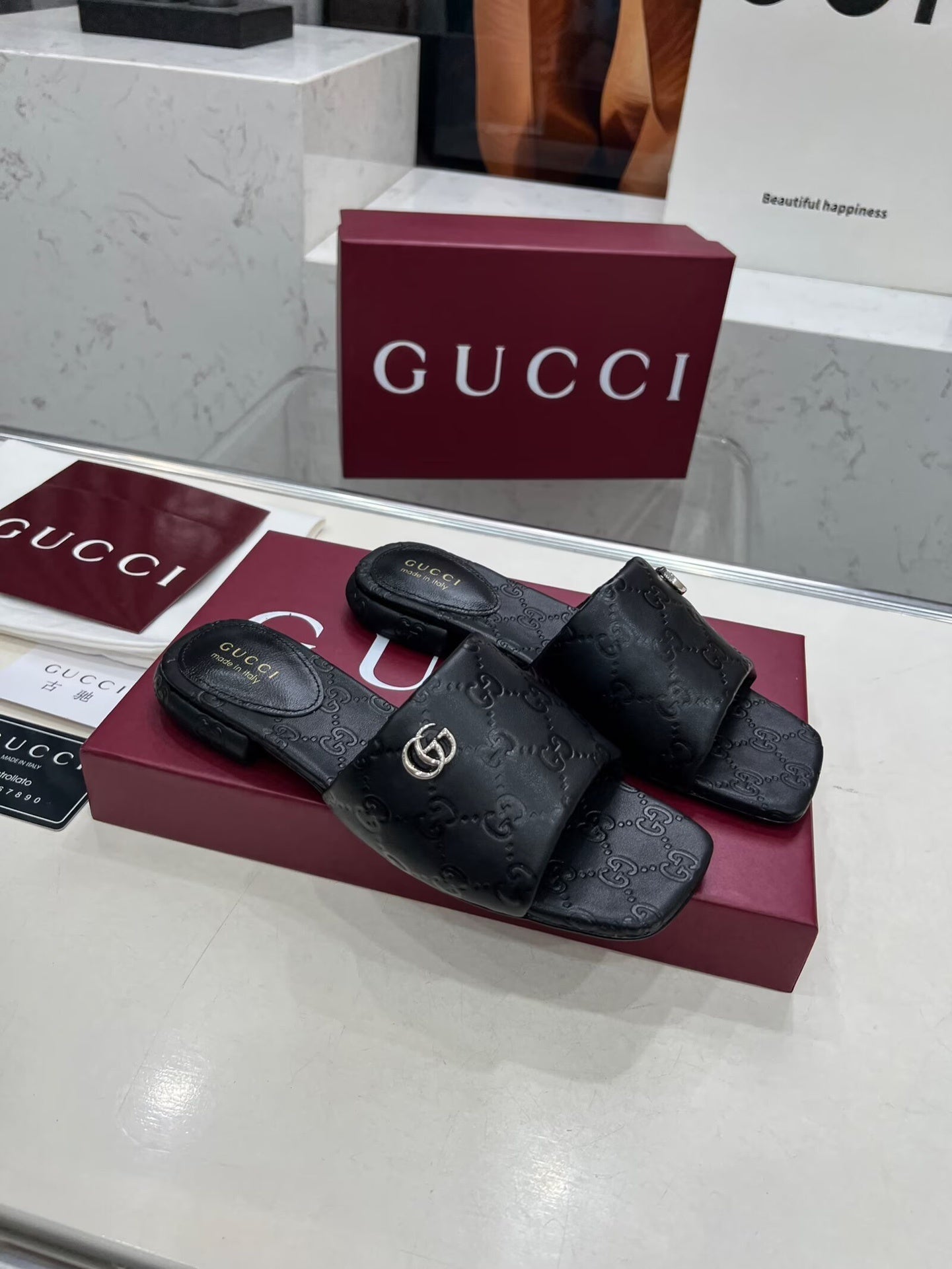 BLACK EMBOSSED LOGO SLIDE SANDALS WITH METAL DETAIL