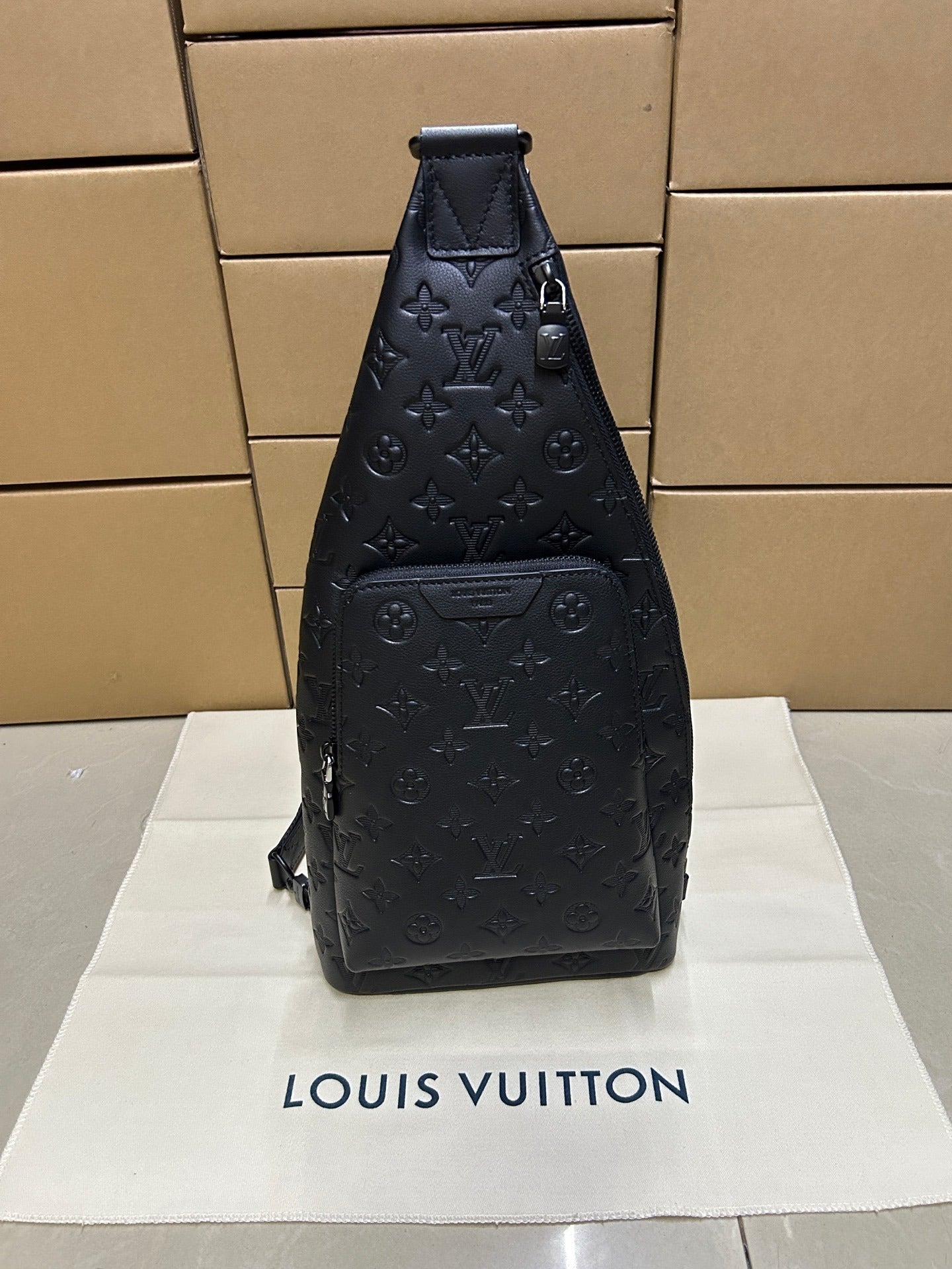 EMBOSSED LEATHER SLING BACKPACK