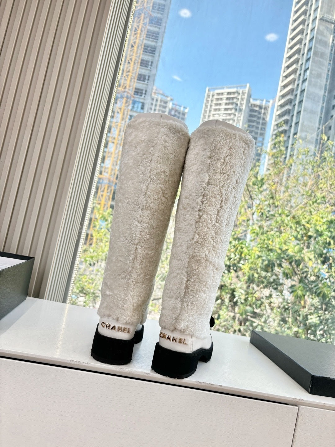 KNEE-HIGH SHEARLING BOOTS WITH PATENT CAP TOE AND BOW DETAIL