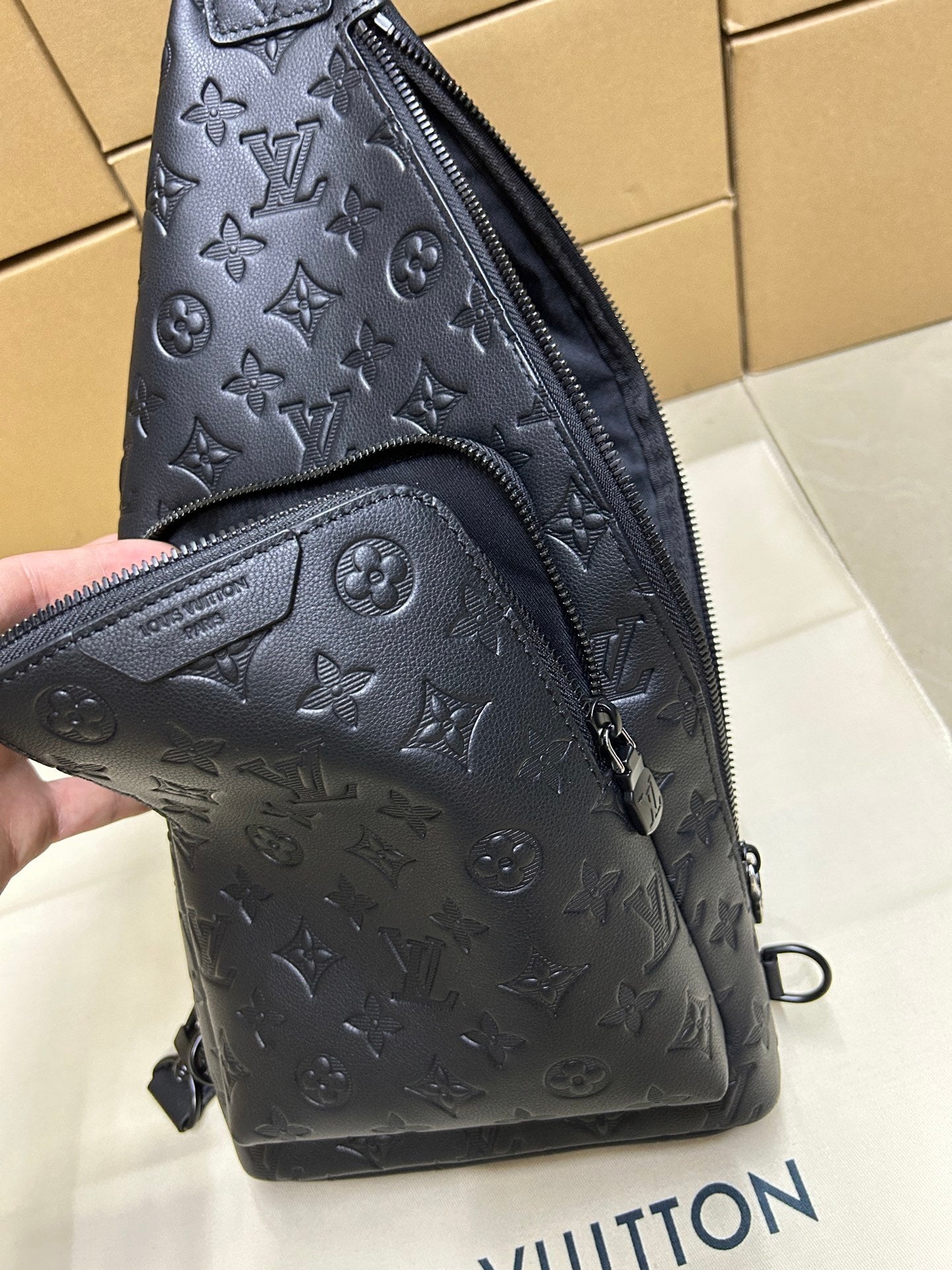 EMBOSSED LEATHER SLING BACKPACK