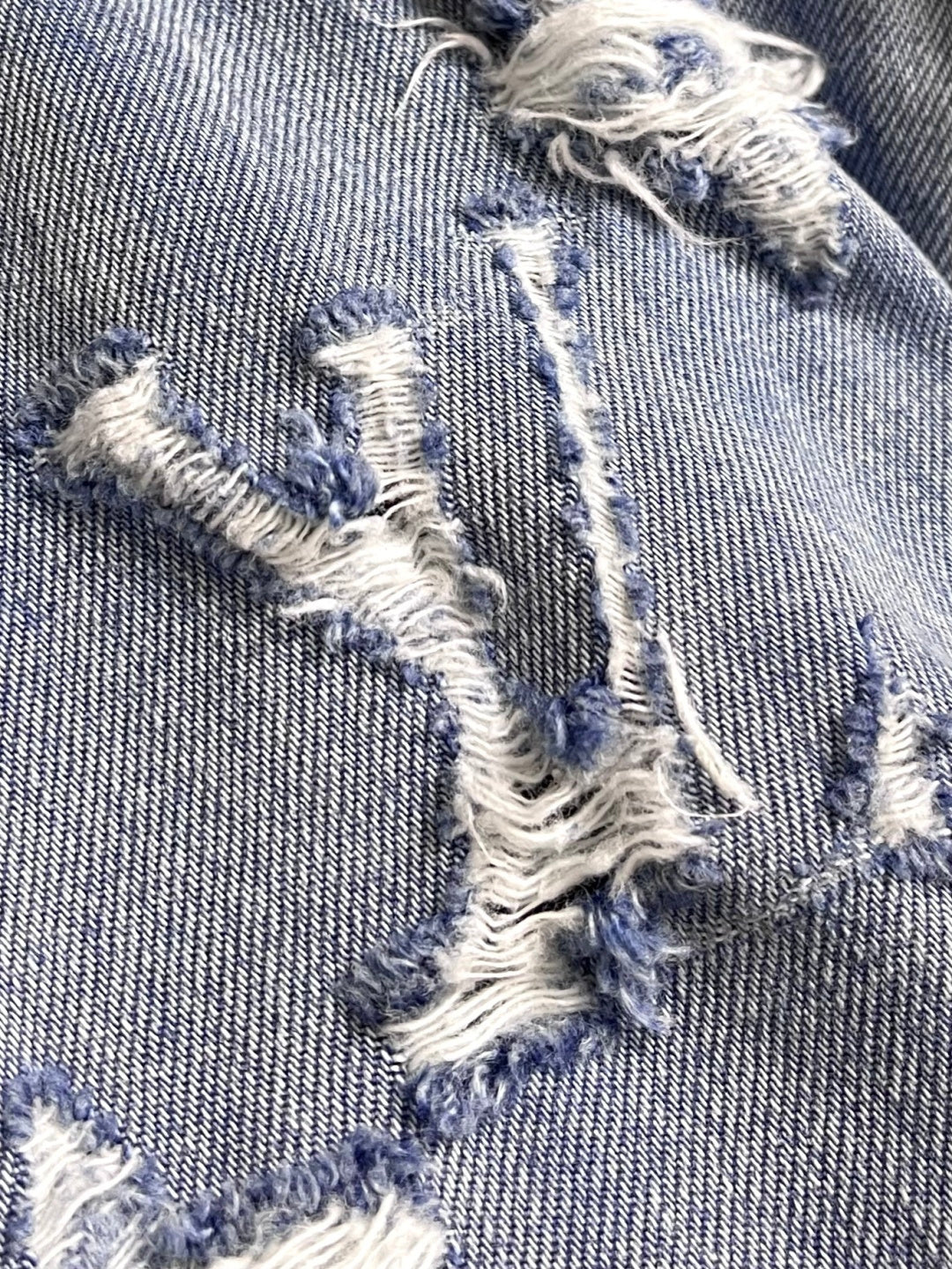 DISTRESSED DENIM TRUCKER JACKET WITH EMBROIDERED DETAILS