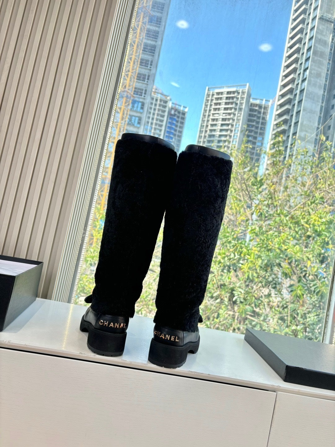 KNEE-HIGH SHEARLING BOOTS WITH PATENT CAP TOE AND BOW DETAIL