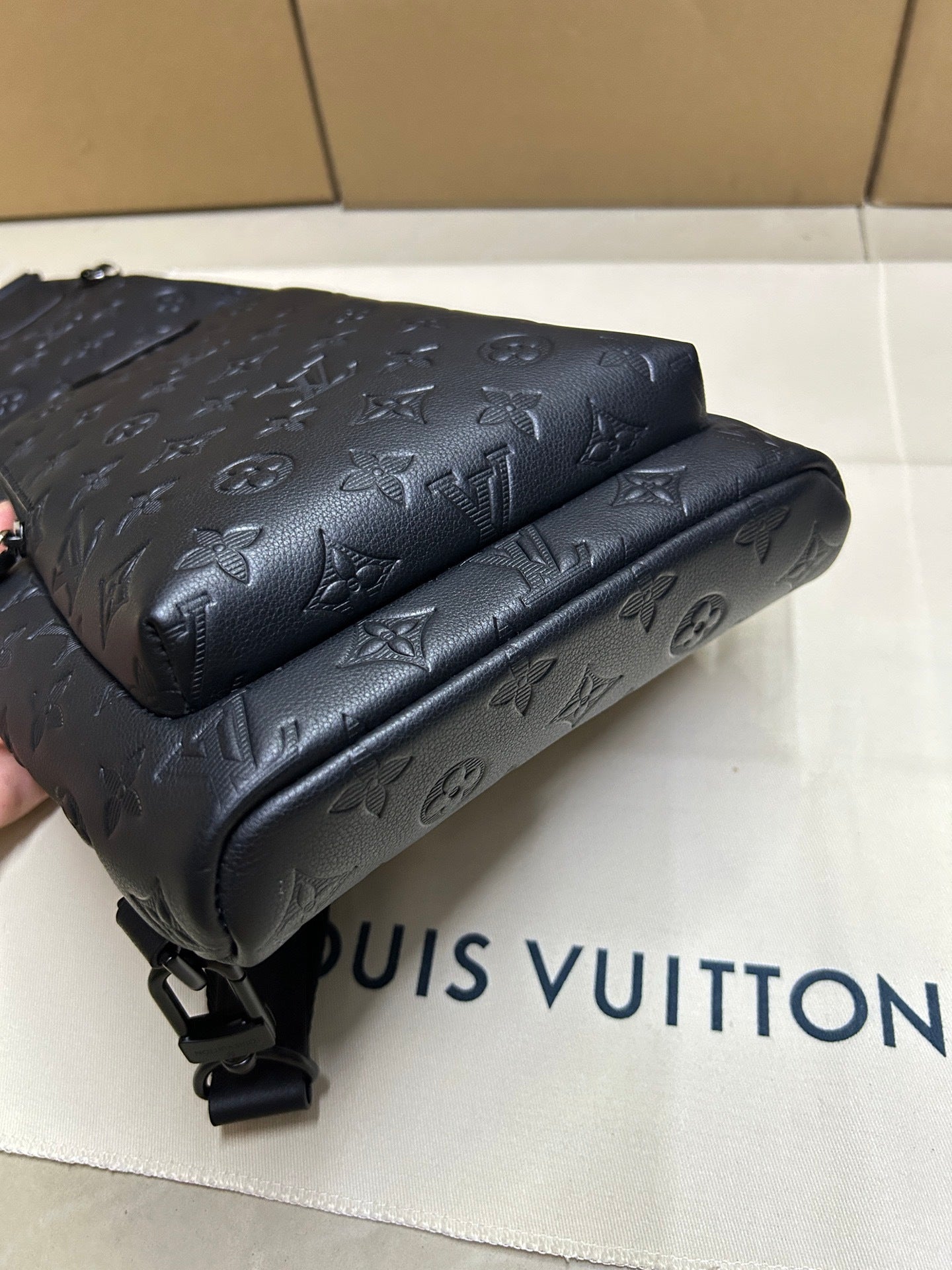 EMBOSSED LEATHER SLING BACKPACK