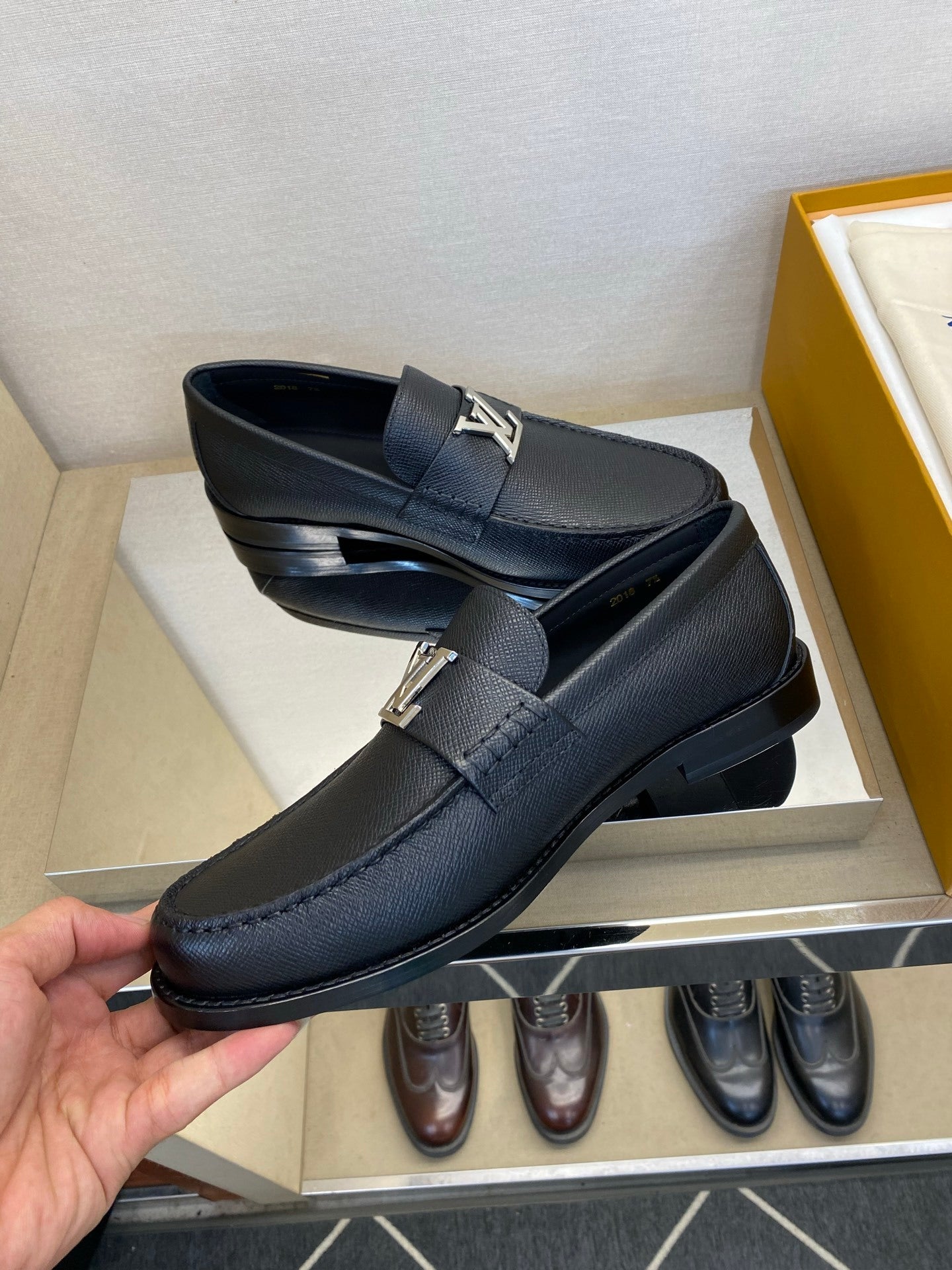 BLACK LEATHER SLIP-ON LOAFERS WITH METAL DETAIL