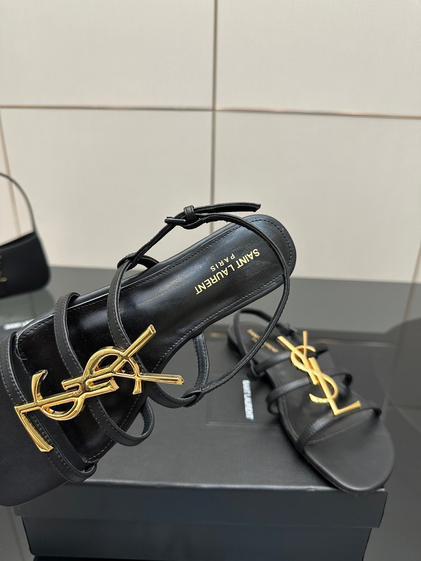 BLACK STRAPPY FLAT SANDALS WITH GOLD LOGO DETAIL