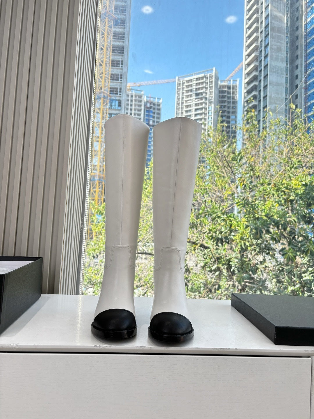 IVORY KNEE-HIGH LEATHER BOOTS WITH BLACK CAP TOE AND BLOCK HEEL