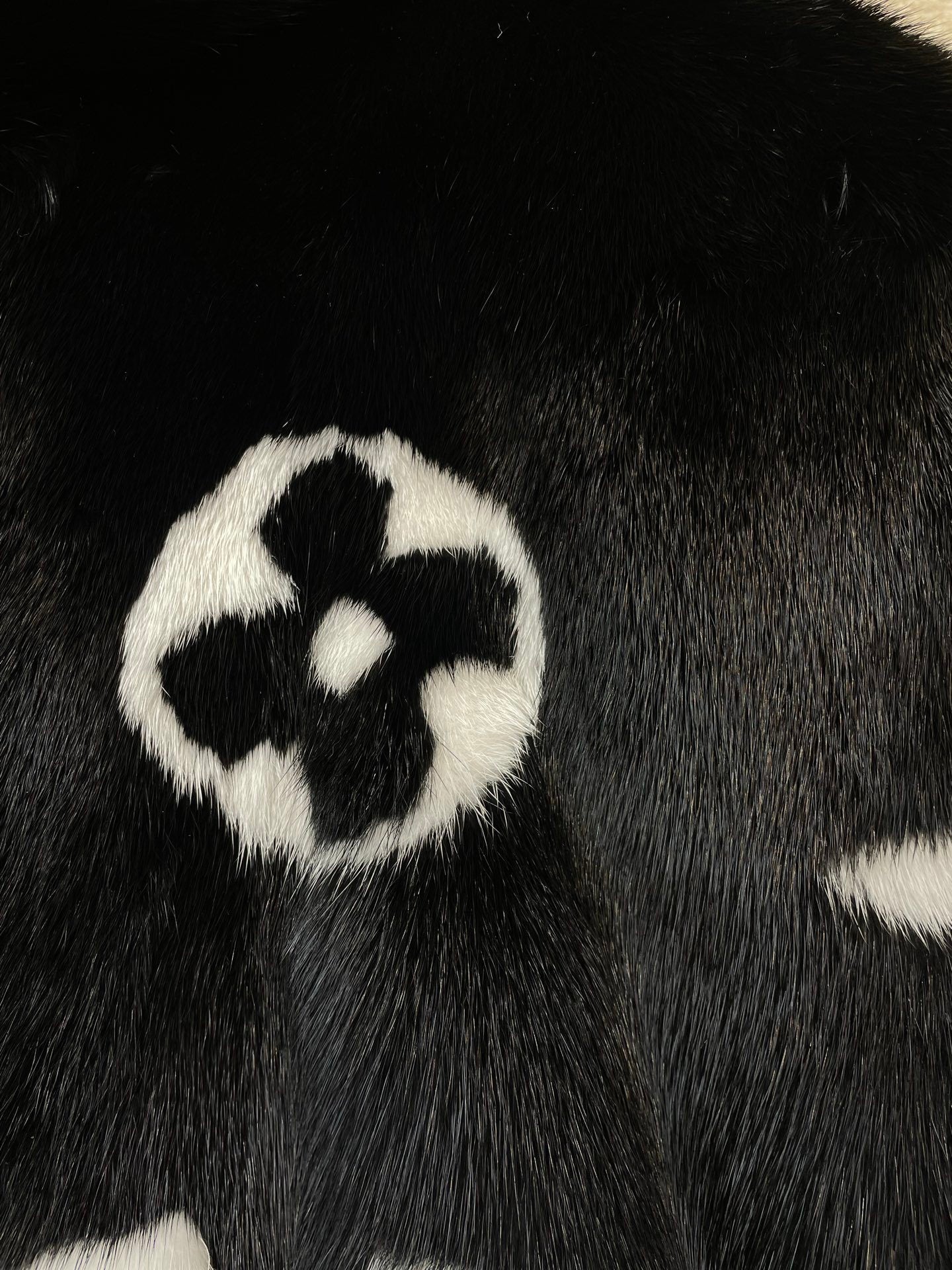 BLACK FAUX FUR HOODED JACKET WITH CONTRAST PATTERN