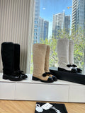 KNEE-HIGH SHEARLING BOOTS WITH PATENT CAP TOE AND BOW DETAIL
