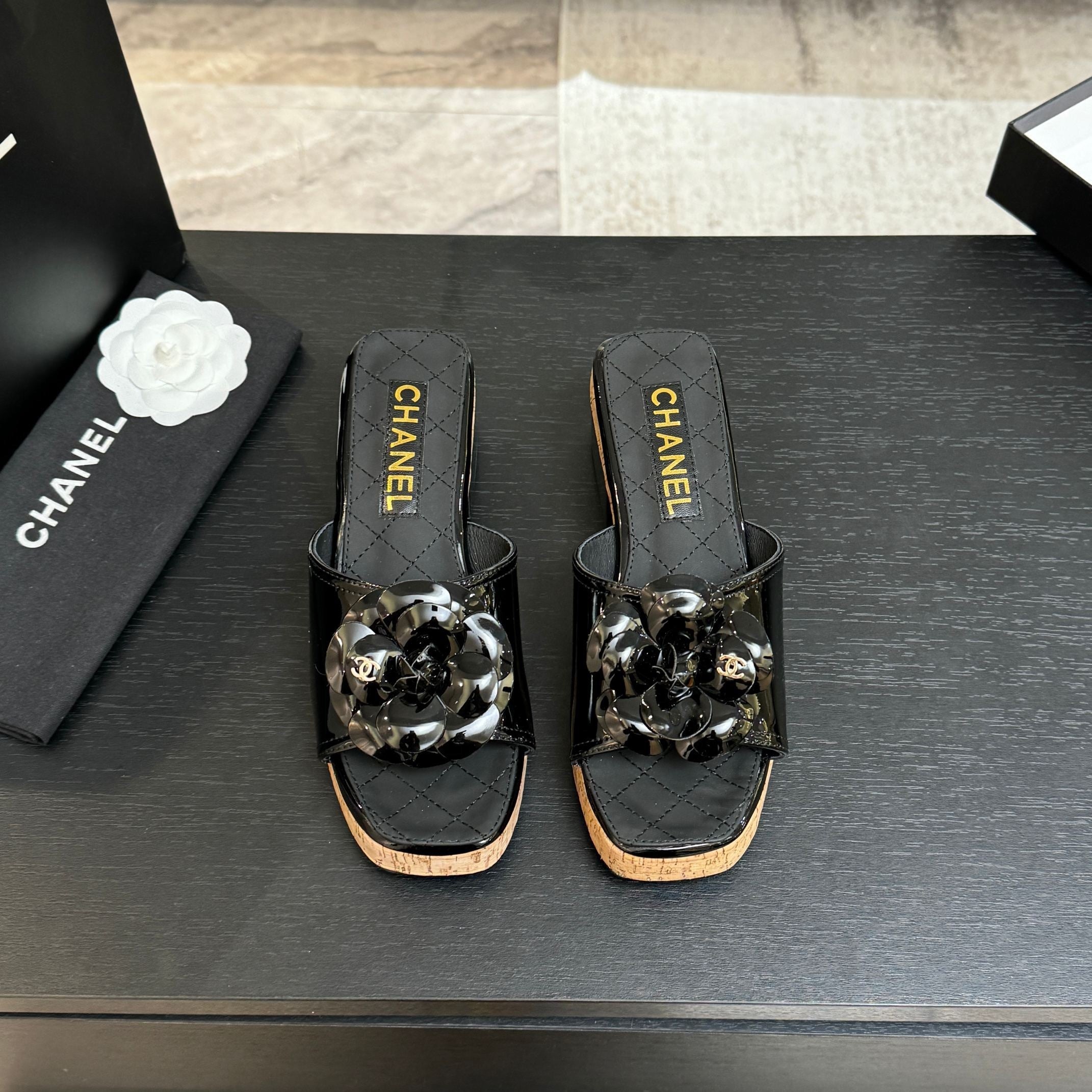 BLACK QUILTED PLATFORM SLIDE SANDALS WITH FLORAL DETAIL