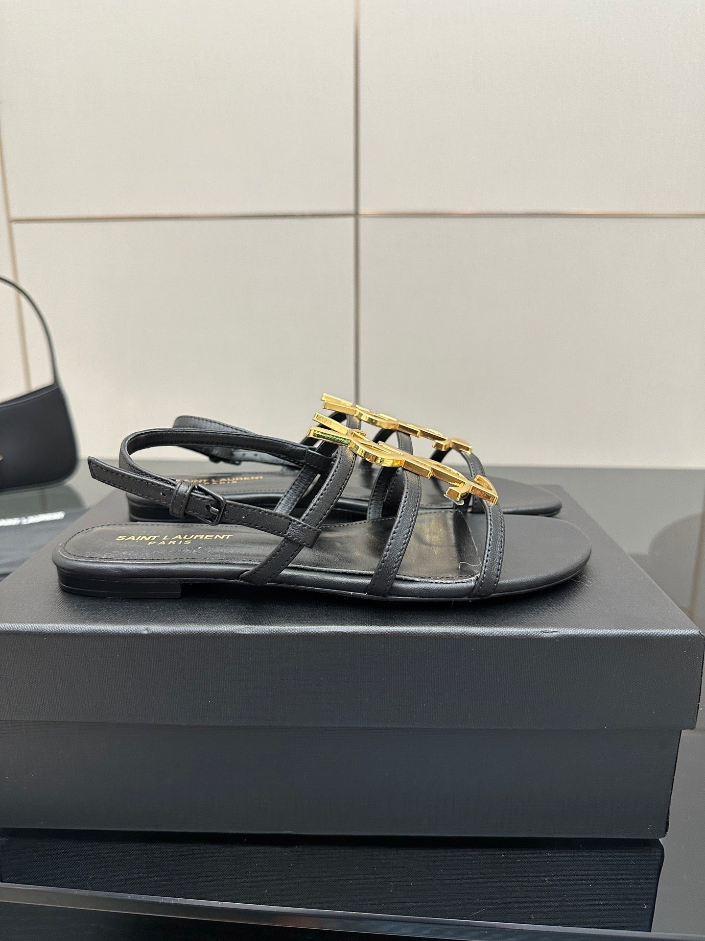 BLACK STRAPPY FLAT SANDALS WITH GOLD LOGO DETAIL
