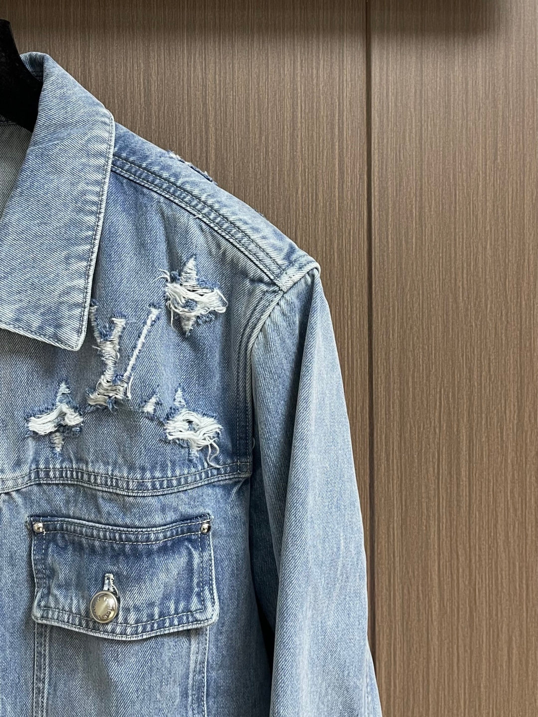 DISTRESSED DENIM TRUCKER JACKET WITH EMBROIDERED DETAILS