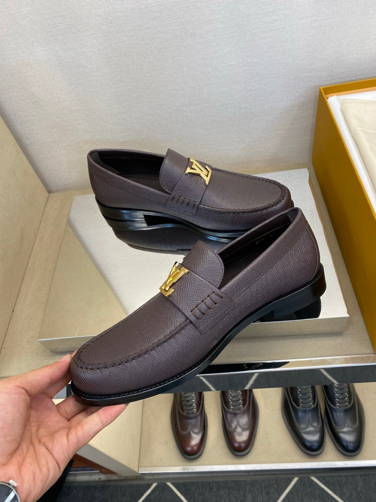 BROWN LEATHER SLIP-ON LOAFERS WITH GOLD-TONE ACCENT