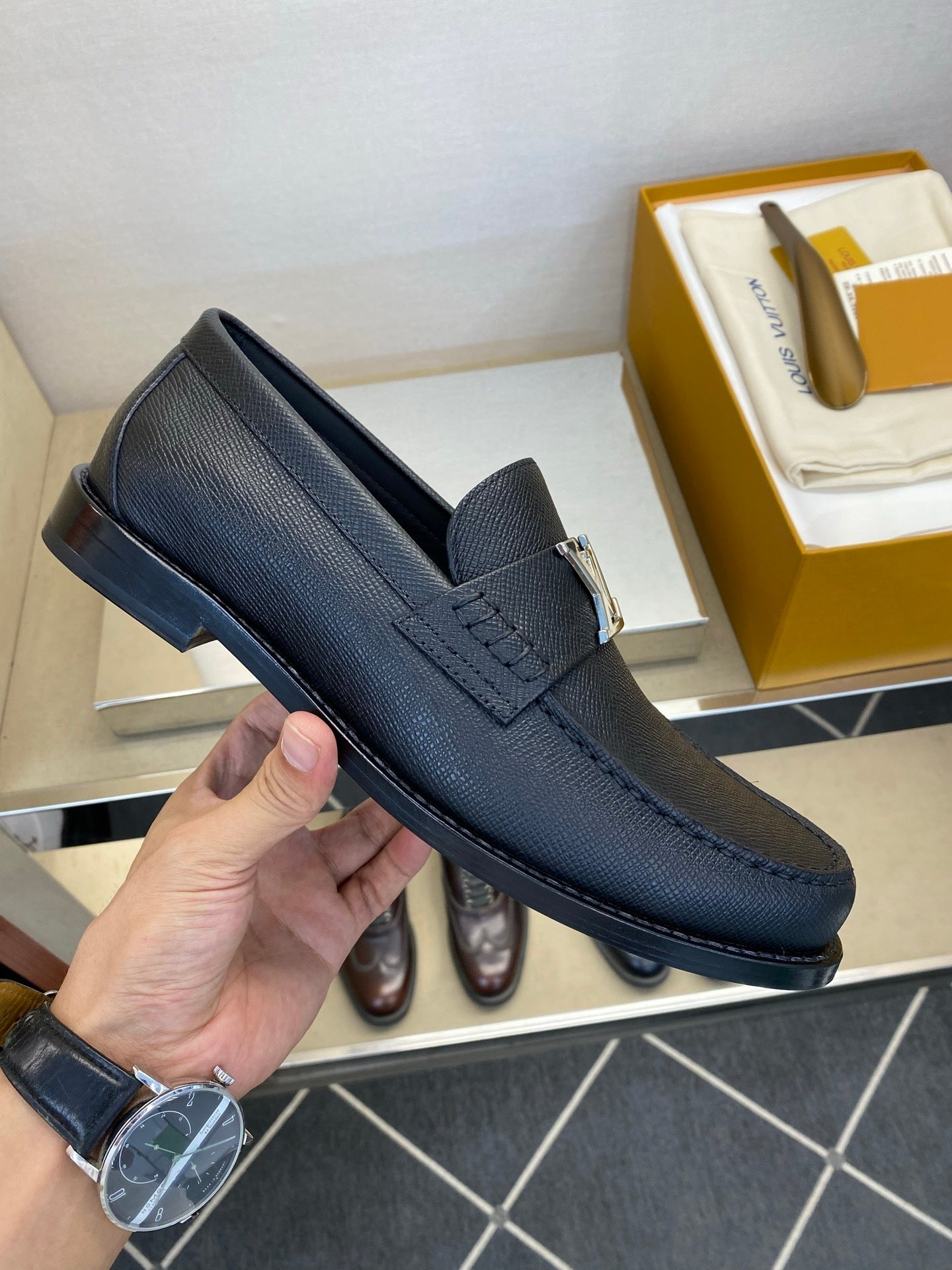 BLACK LEATHER SLIP-ON LOAFERS WITH METAL DETAIL