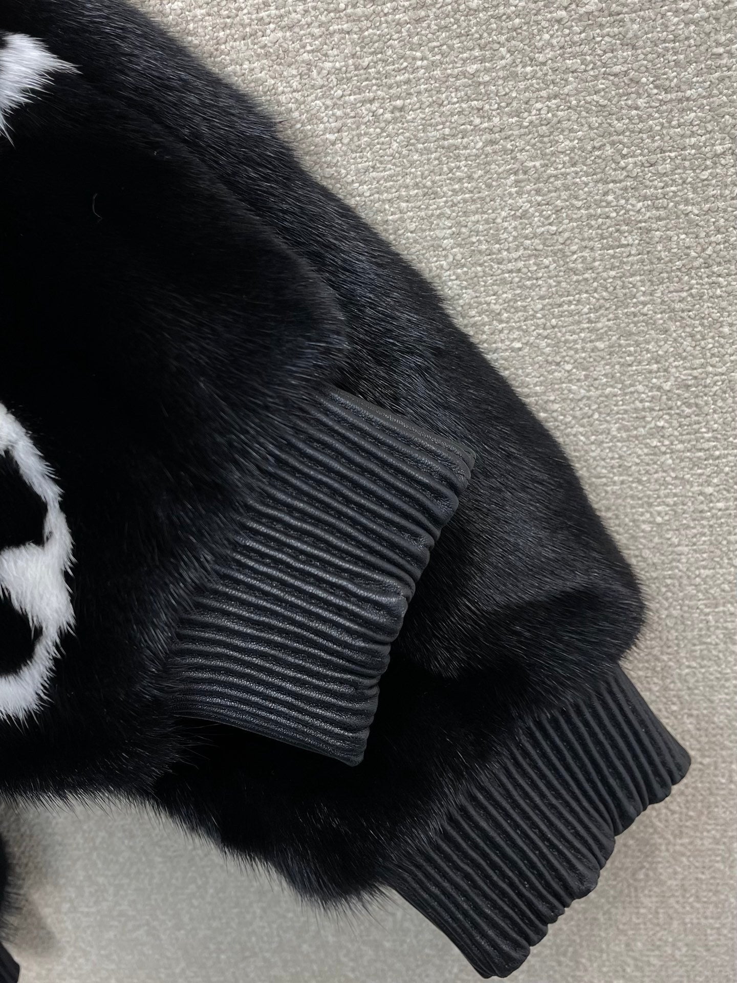 BLACK FAUX FUR HOODED JACKET WITH CONTRAST PATTERN