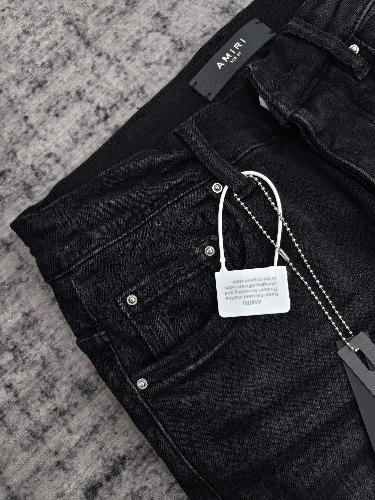 DISTRESSED LOGO APPLIQUÉ SKINNY JEANS