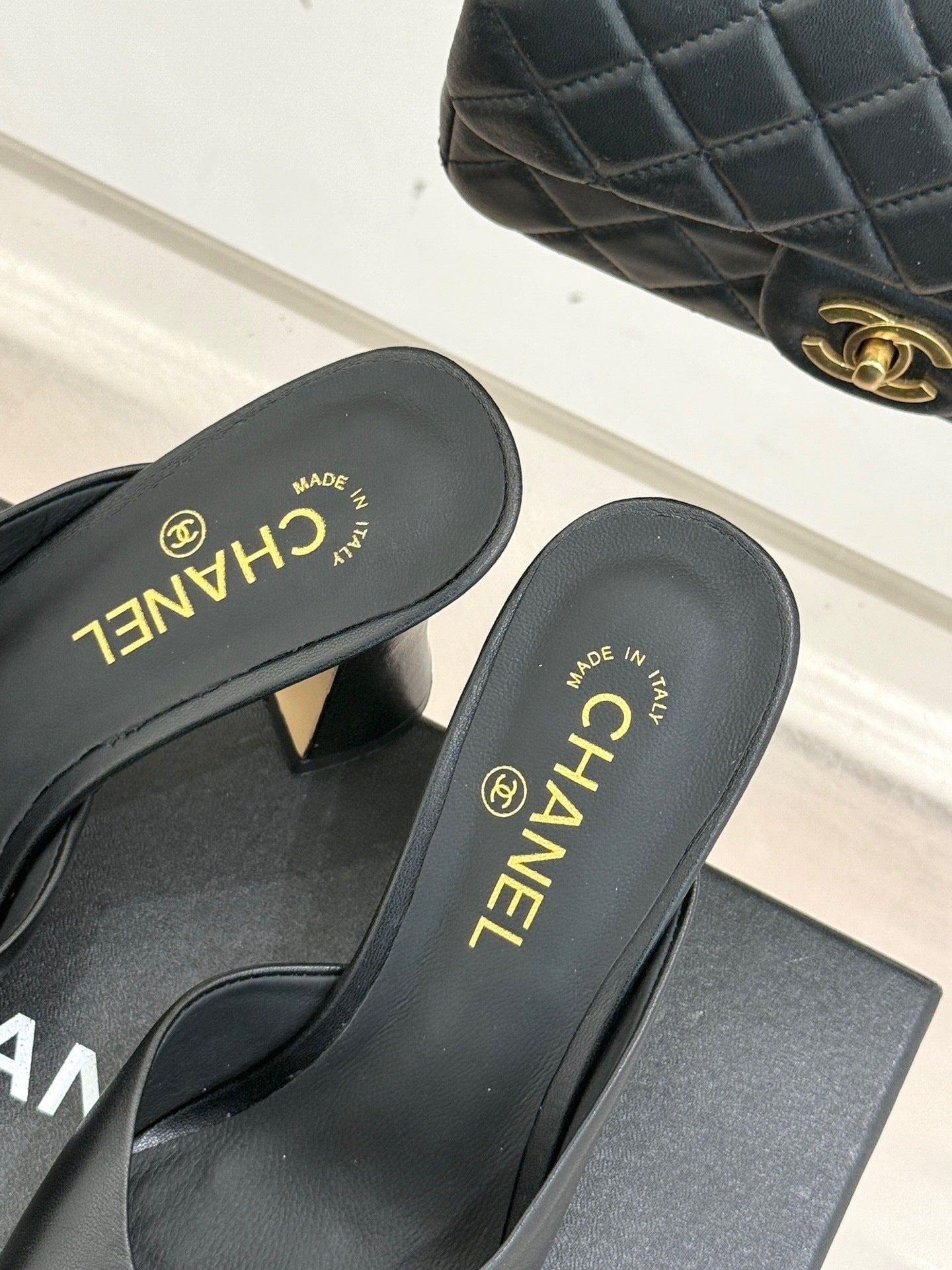 BLACK LEATHER CAP-TOE MULE HEELS WITH GOLD DETAIL