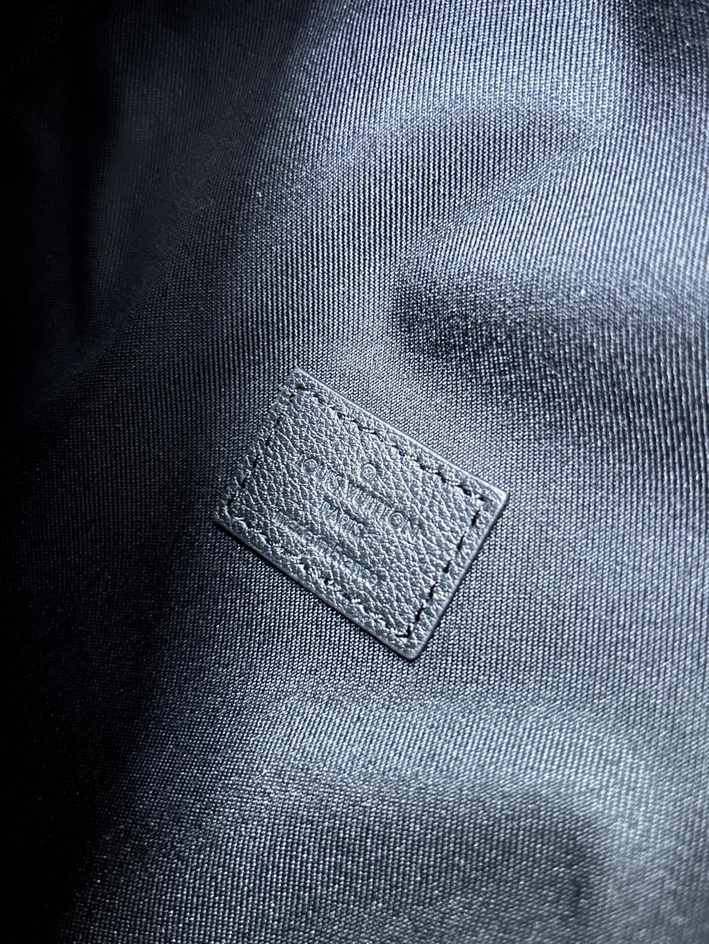 EMBOSSED LEATHER SLING BACKPACK