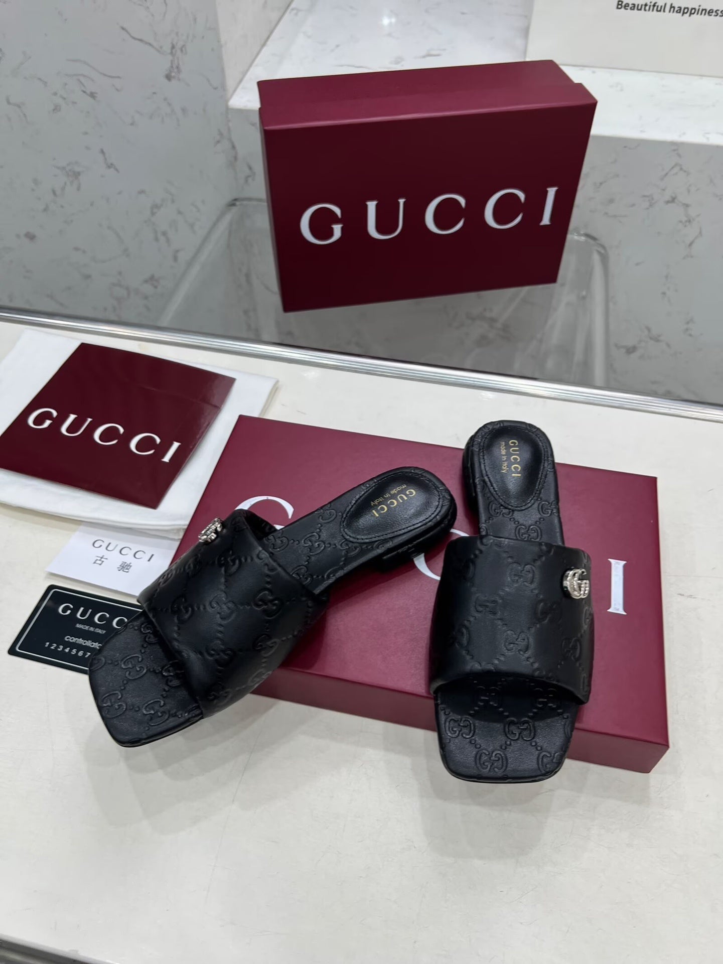 BLACK EMBOSSED LOGO SLIDE SANDALS WITH METAL DETAIL