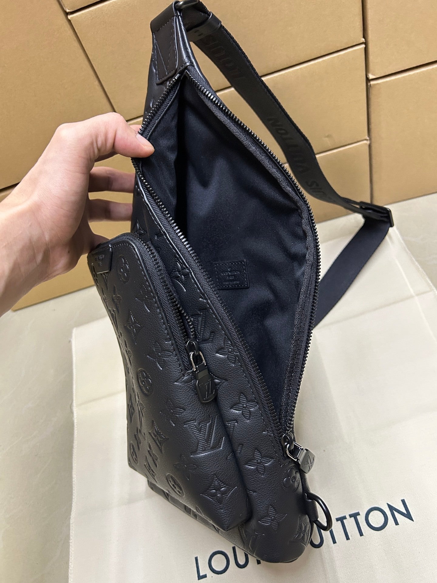 EMBOSSED LEATHER SLING BACKPACK
