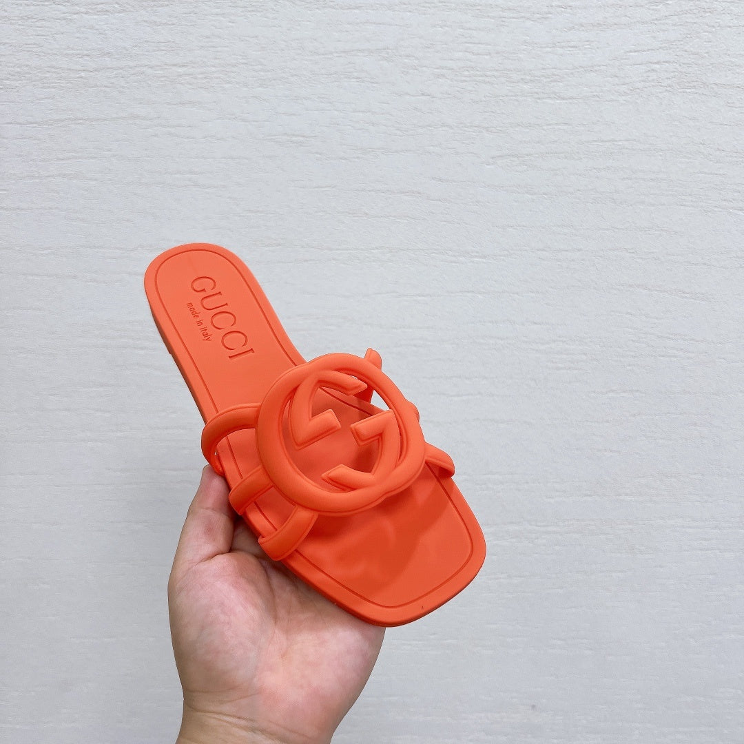 NEON ORANGE RUBBER SLIDE SANDALS WITH ROUND EMBLEM