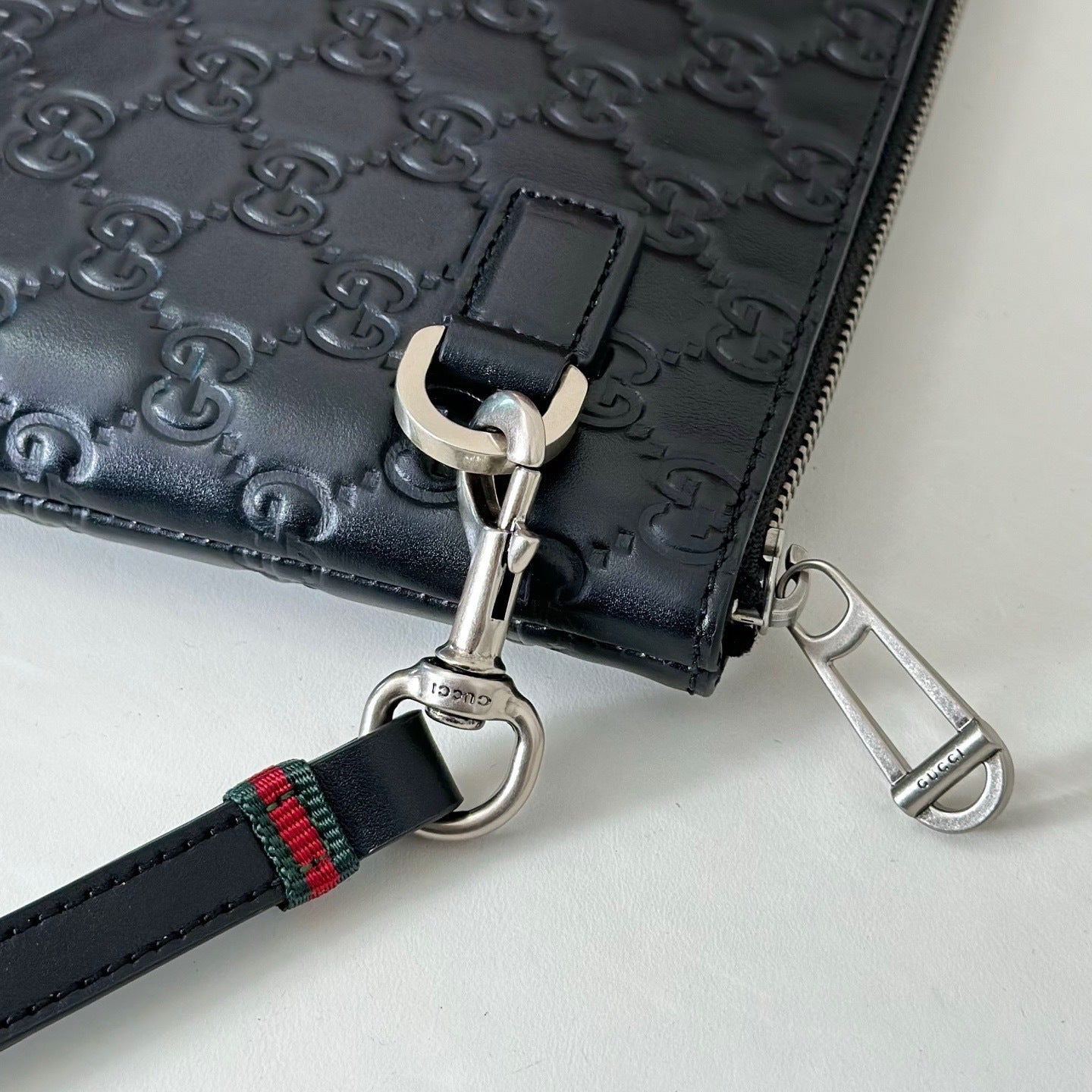 EMBOSSED LEATHER WRISTLET CLUTCH