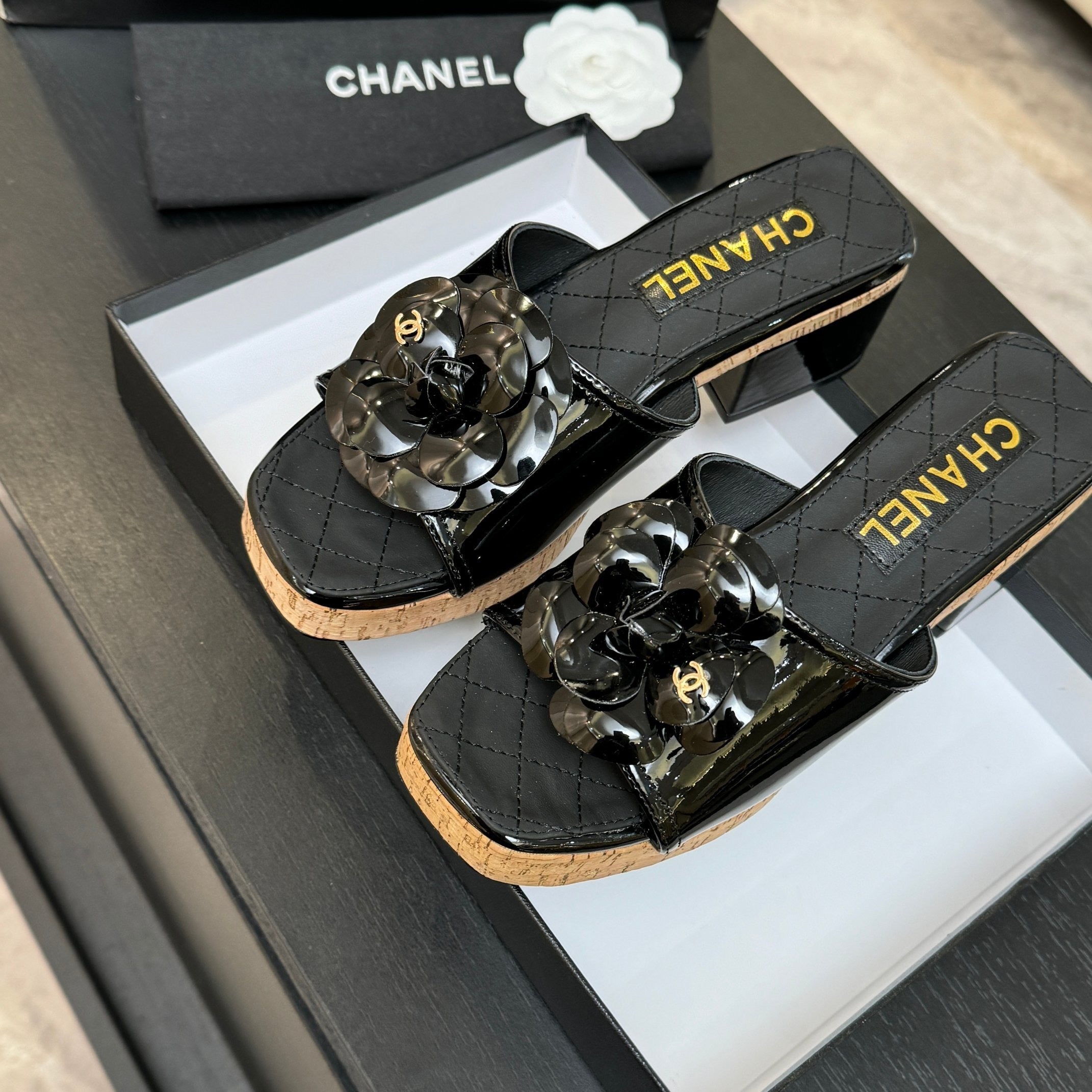 BLACK QUILTED PLATFORM SLIDE SANDALS WITH FLORAL DETAIL