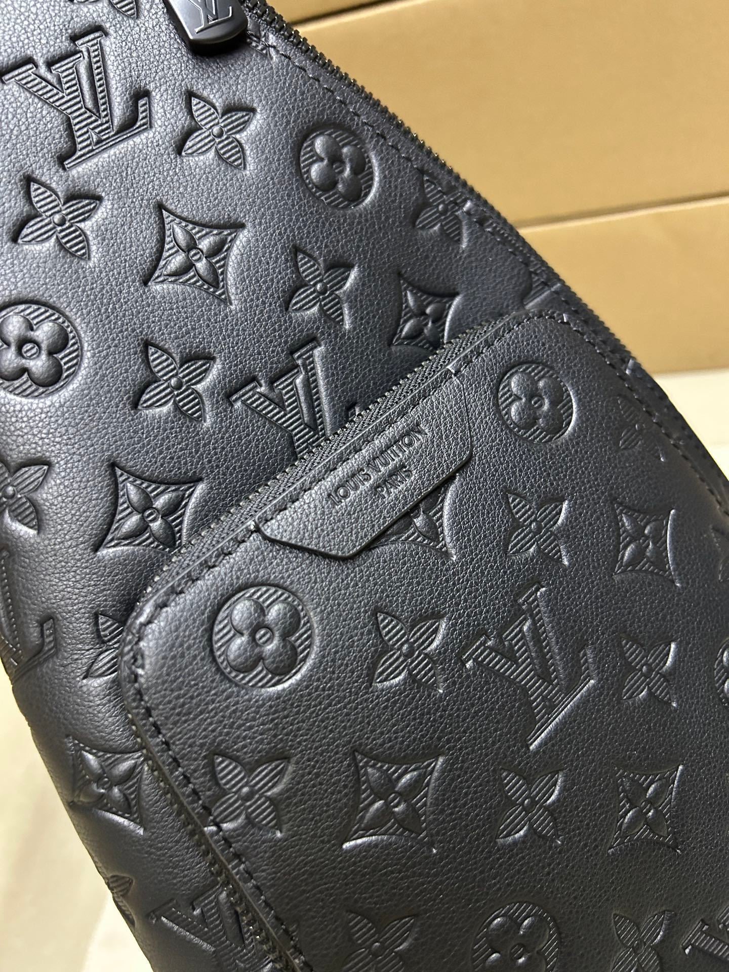 EMBOSSED LEATHER SLING BACKPACK