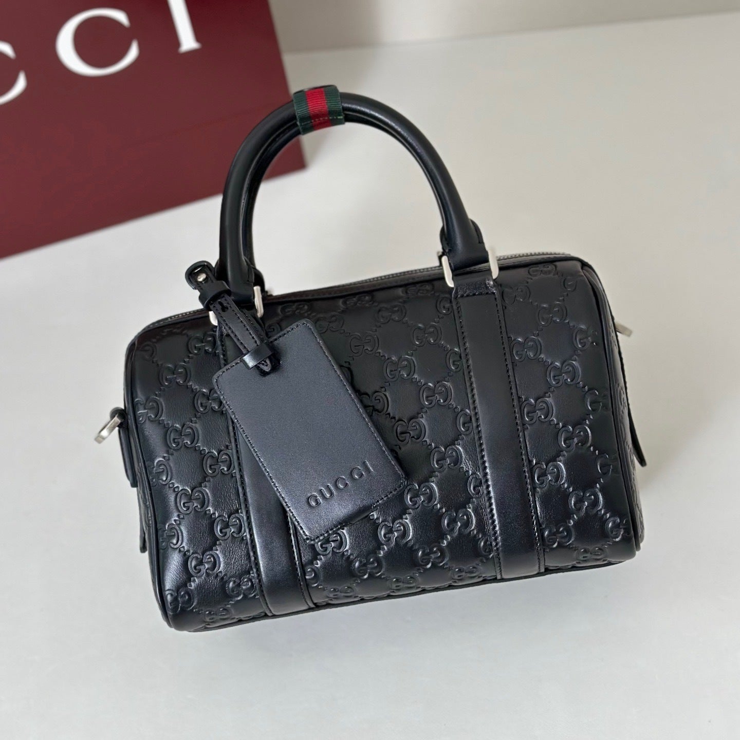 EMBOSSED LEATHER TOP HANDLE BAG