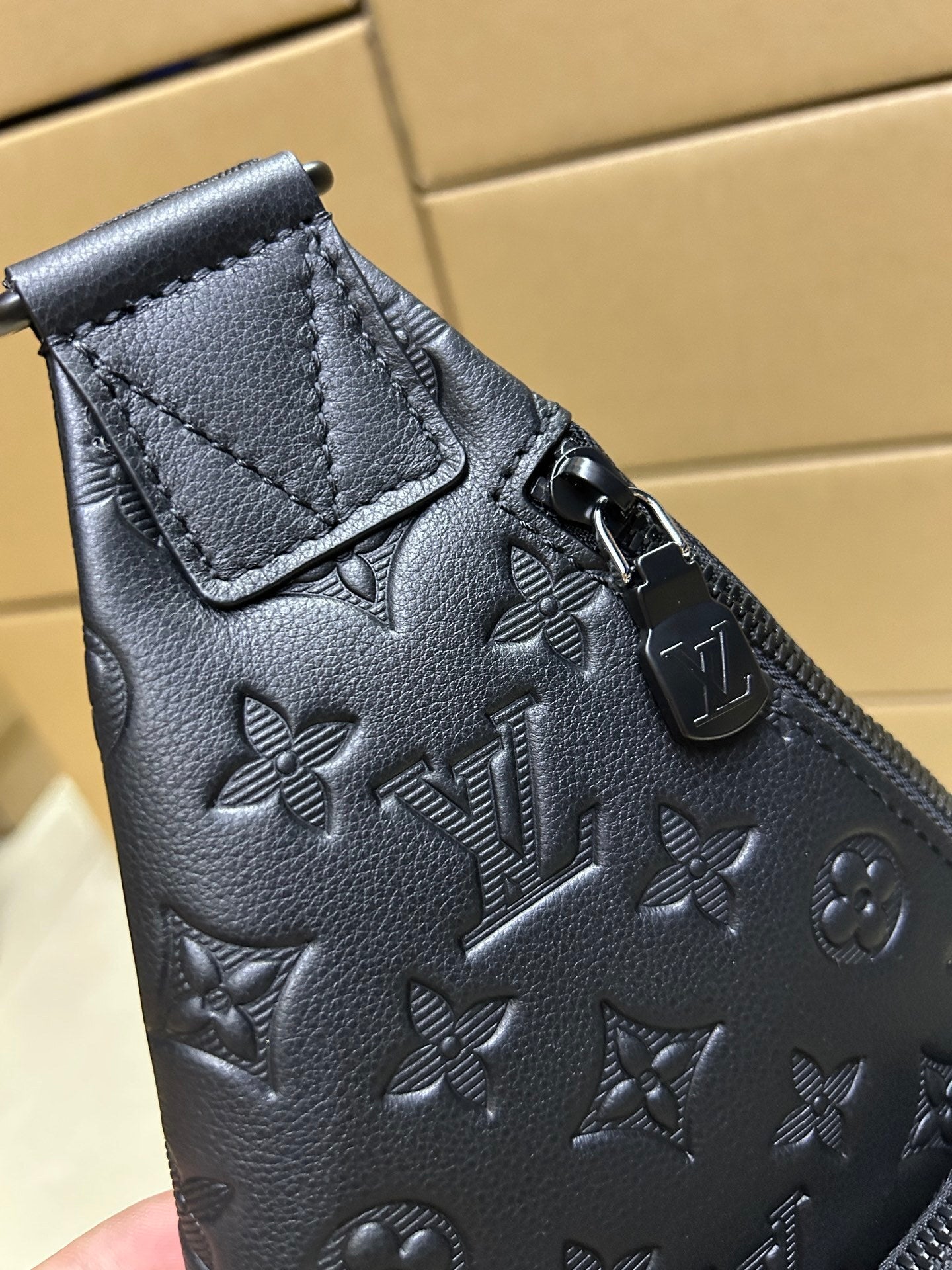 EMBOSSED LEATHER SLING BACKPACK