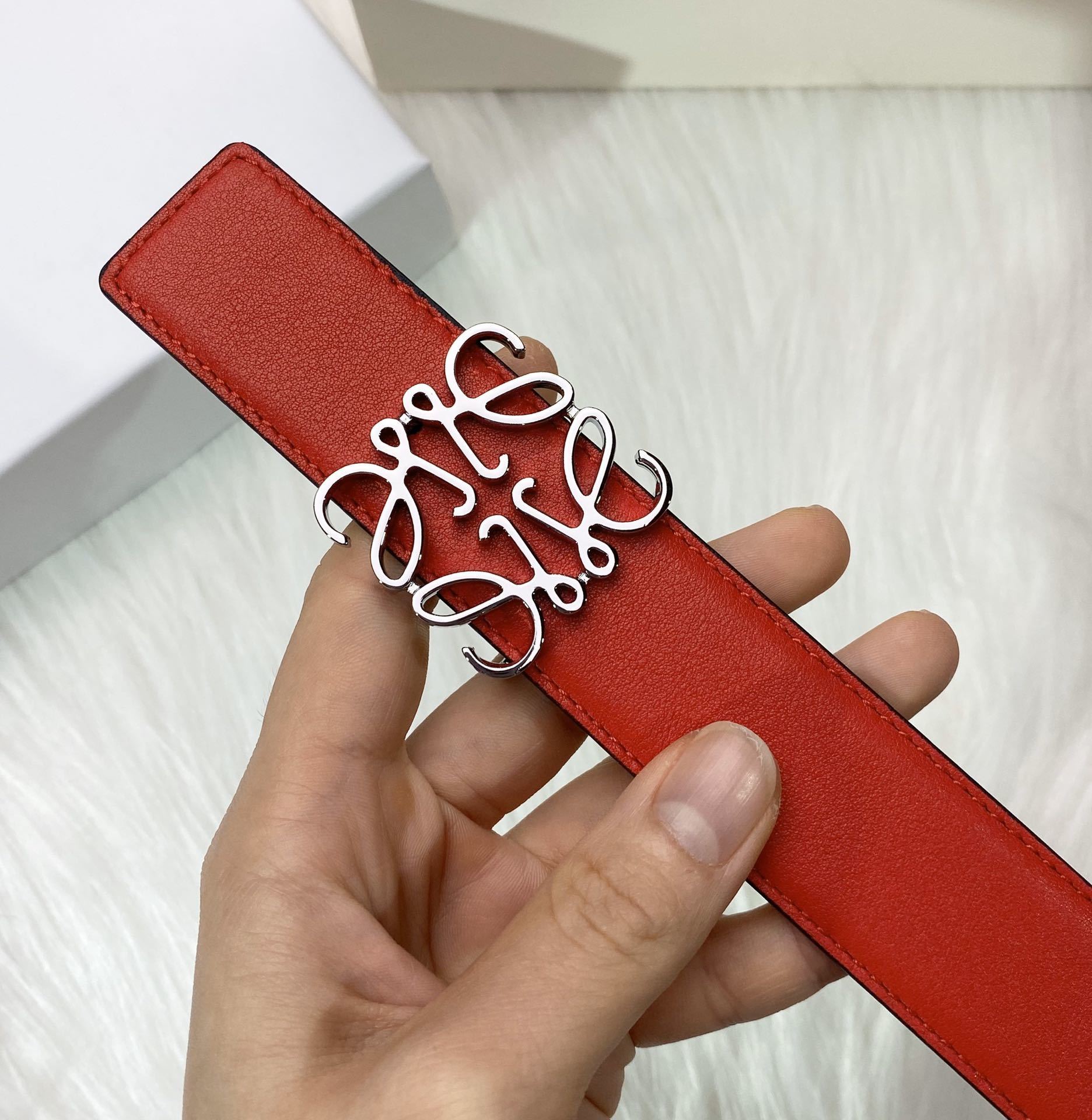 RED LEATHER BELT WITH SILVER ANAGRAM BUCKLE
