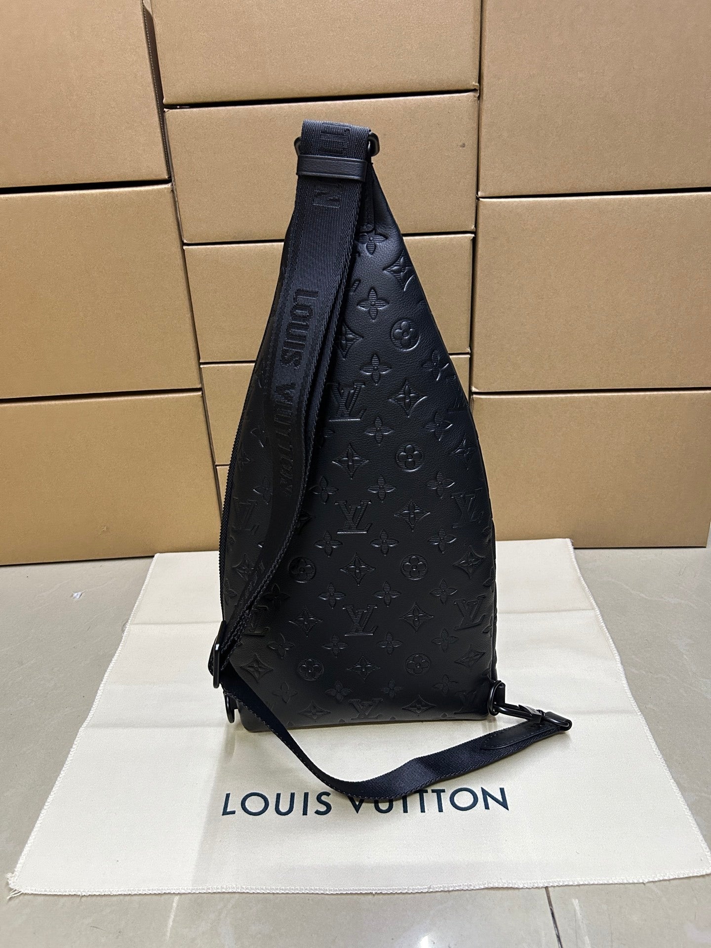 EMBOSSED LEATHER SLING BACKPACK