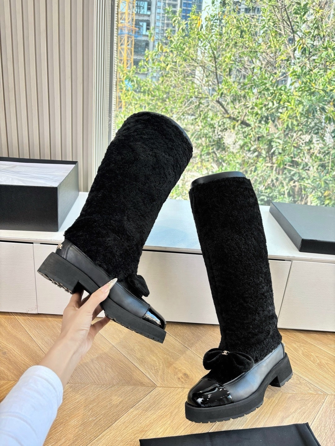 KNEE-HIGH SHEARLING BOOTS WITH PATENT CAP TOE AND BOW DETAIL